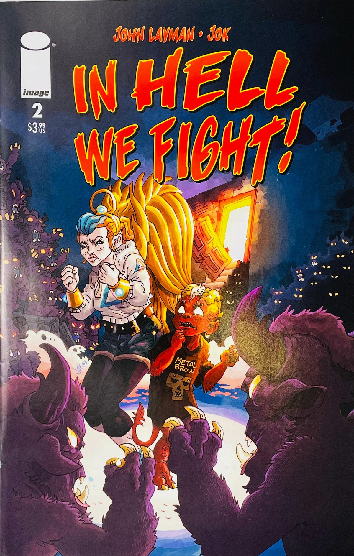 In Hell We Fight issue 2 cover by Jok featuring an angelic girl and a small red demon surrounded by looming horned monsters.