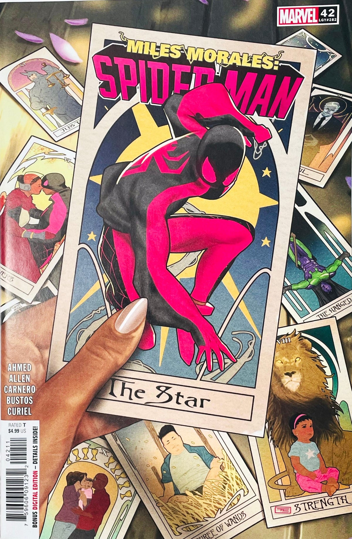 Miles Morales: Spider-Man issue 42 comic book published by Marvel Comics featuring Taurin Clarke cover art of a hand holding a custom The Star tarot card showing Miles Morales.