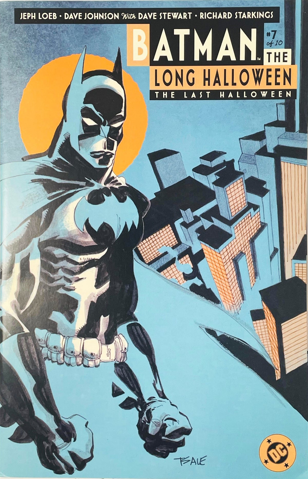Batman standing on a Gotham City rooftop overlooking skyscraper buildings under a orange moon on Dave Johnson cover of Batman The Long Halloween The Last Halloween issue 7.