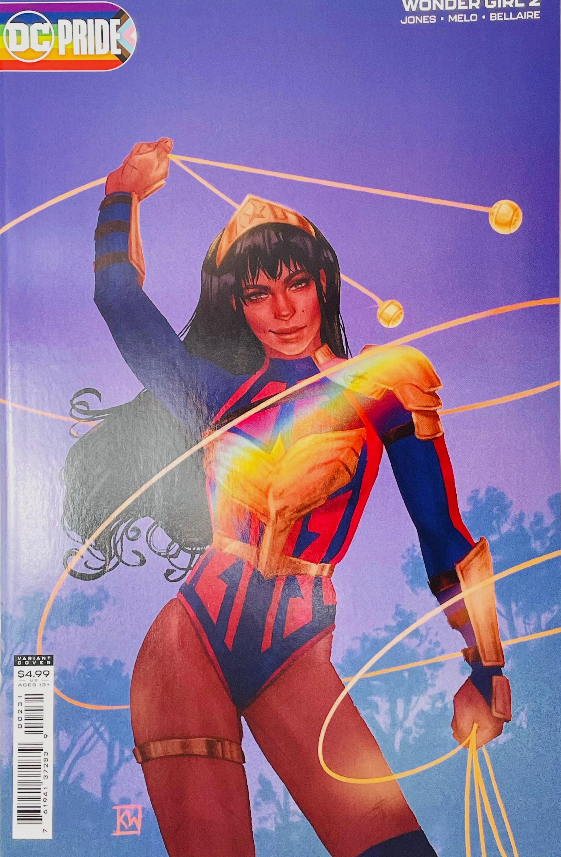 Wonder Girl issue 2 DC Pride variant cover by Kevin Wada featuring Yara Flor twirling glowing golden bolas with a rainbow light refraction across her armor.