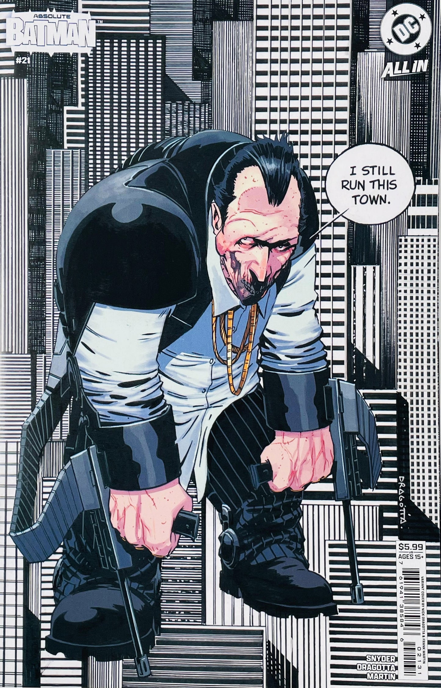 Batman comic book cover featuring a stylized illustration of a man in a black and white suit with a gold chain, holding two rifles, set against a black and white cityscape. The top left corner shows the Batman logo, and the top right shows the DC logo.