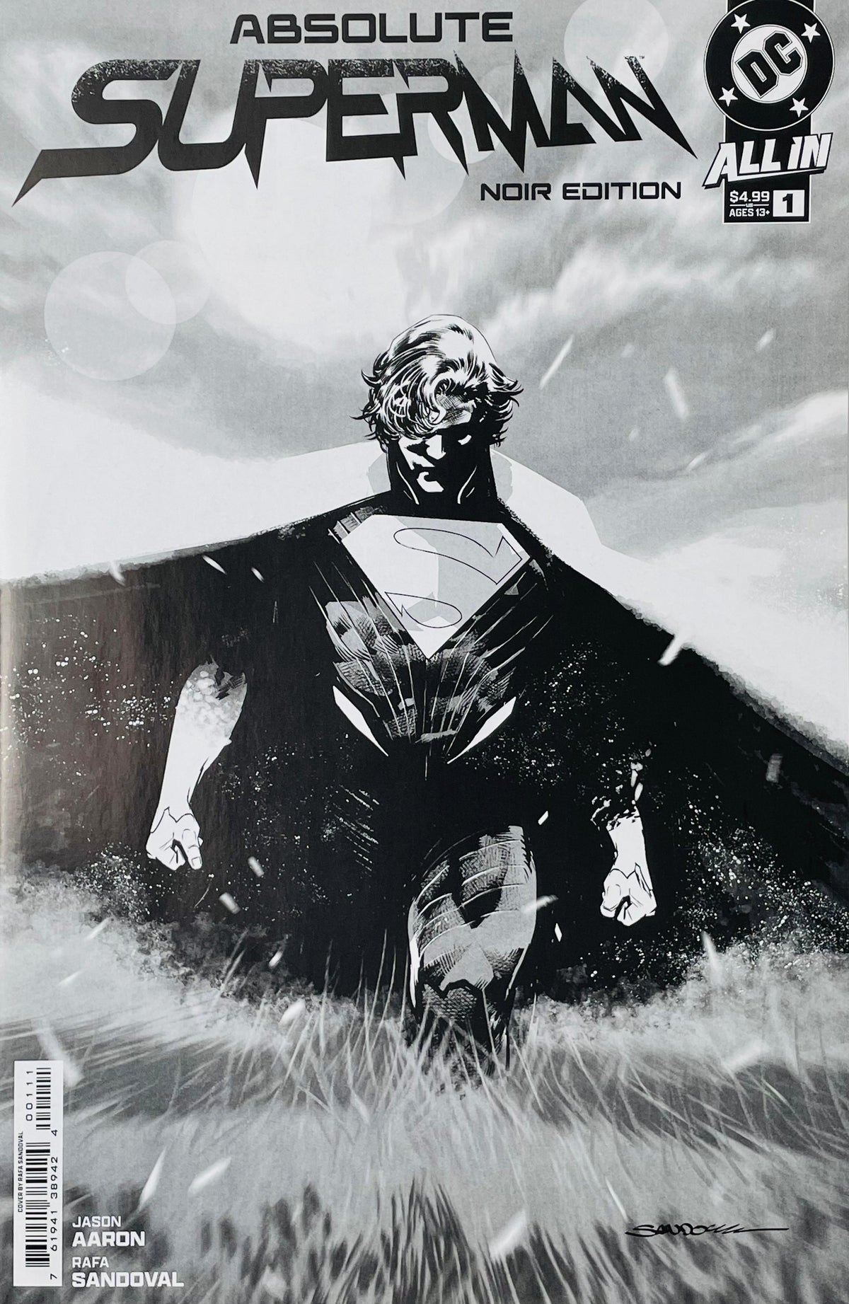 Absolute Superman issue 1 Noir Edition black and white cover showing Superman walking through tall grass with a wide cape spreading out behind him.