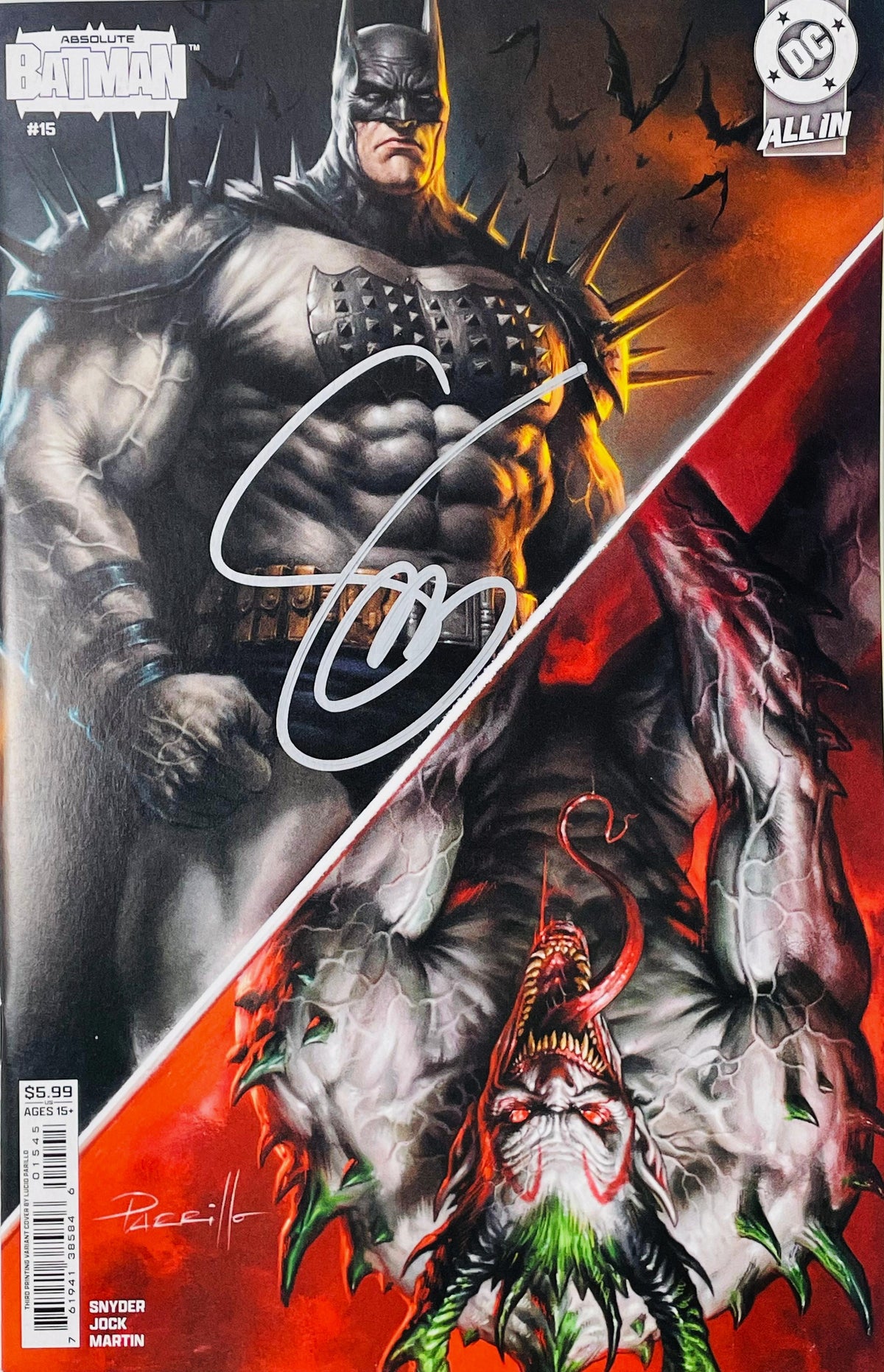 Signed Absolute Batman issue 15 variant cover by Lucio Parrillo showing a split artwork of armored Batman and a monstrous Joker with a silver signature.
