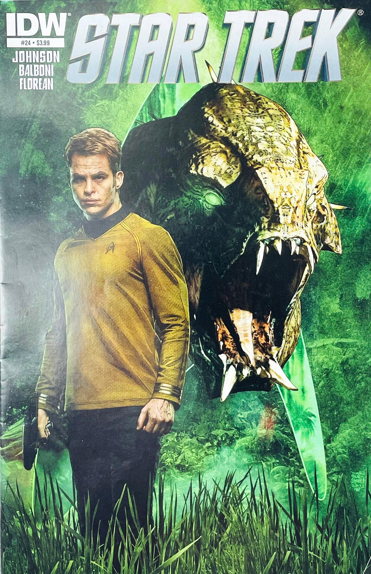 Star Trek issue 24 comic book published by IDW Publishing featuring Tim Bradstreet cover art of Chris Pine as Captain James T. Kirk standing in front of a giant alien monster.
