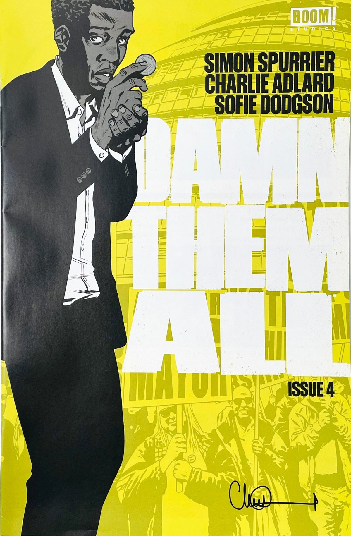 Damn Them All issue 4 comic book published by BOOM Studios featuring Charlie Adlard cover art of a suited man holding a coin on a bright yellow background.
