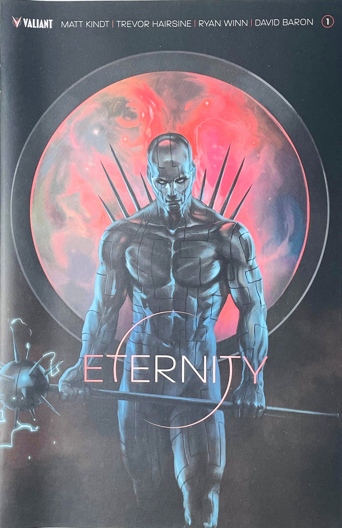 Eternity issue 1 comic book published by Valiant Entertainment featuring Jelena Kevic-Djurdjevic cover art of metallic god-like figure Divinity holding a staff before a red planet.