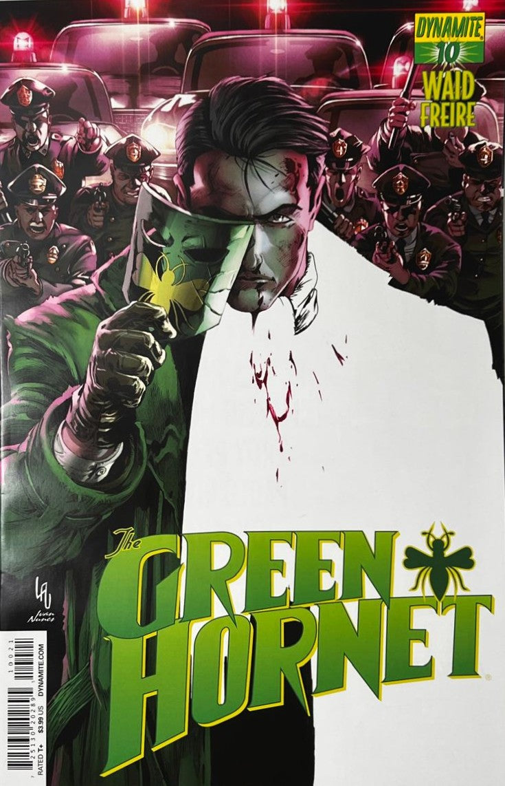 The Green Hornet issue 10 comic book published by Dynamite Entertainment featuring Ivan Nunes cover art of Britt Reid removing his mask while surrounded by police officers and squad cars.