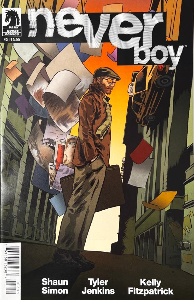 Neverboy issue 2 comic book published by Dark Horse Comics featuring Tyler Jenkins cover art of a man carrying a case as reality warps and artwork pages float around him.