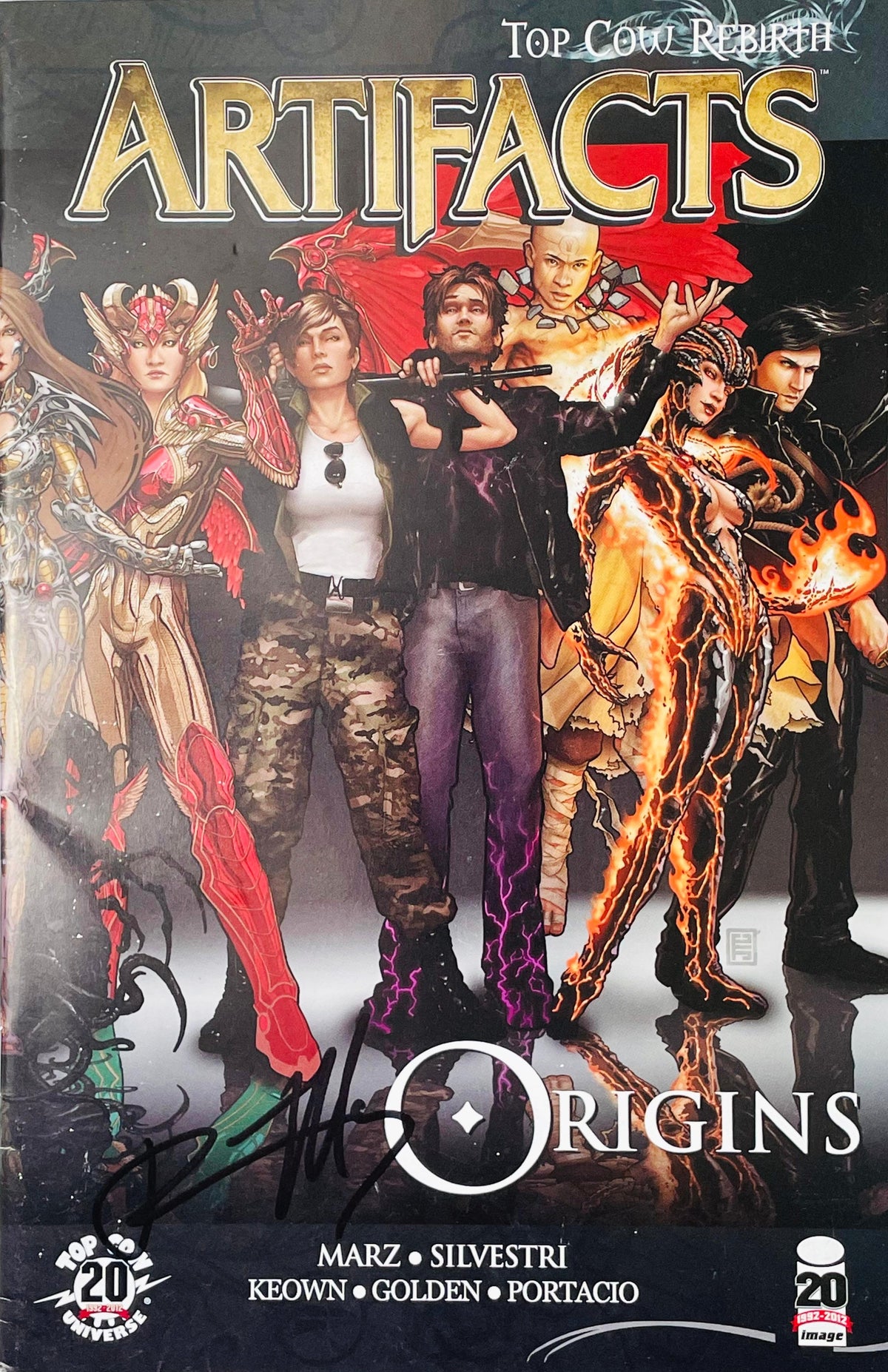 Artifacts Origins signed graphic novel trade paperback published by Top Cow and Image Comics featuring cover art of 13 Artifact wielders and black marker signature.