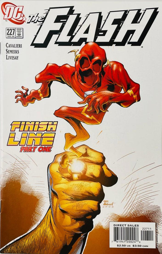 A giant hand holding up a glowing golden Flash ring with a red ghost-like Flash figure emerging from it on the cover of The Flash 227 by Art Thibert for DC Comics.