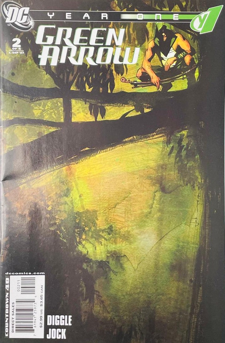 Oliver Queen as Green Arrow in hooded survival attire crouched on jungle tree branches holding a bow on the cover of Green Arrow Year One 2 by Jock for DC Comics.